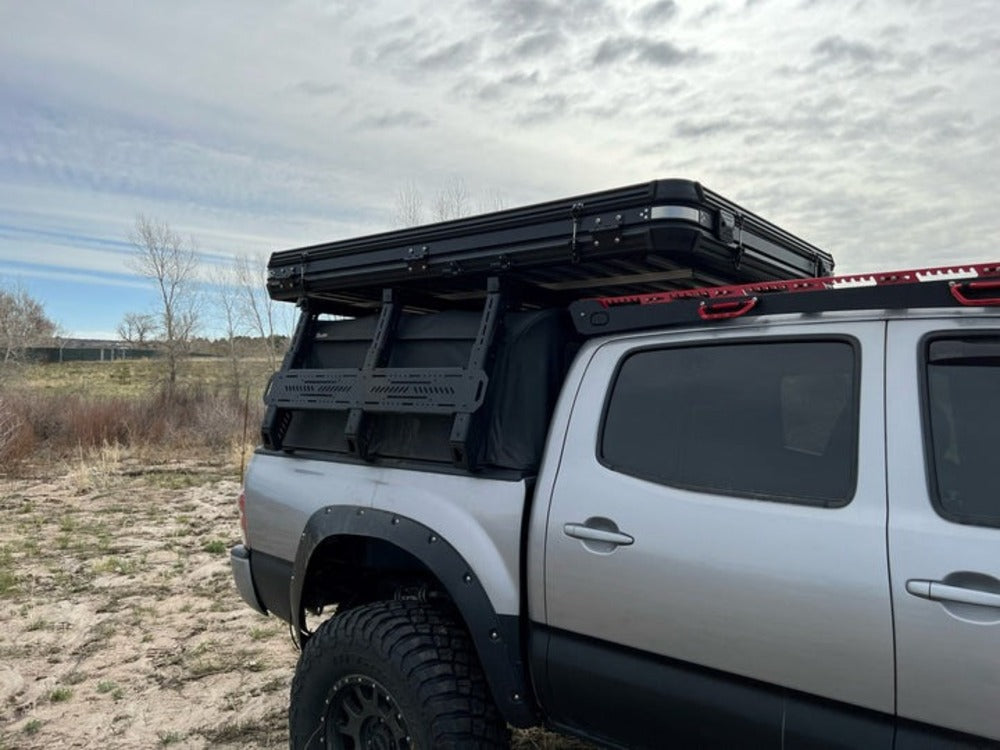 upTOP Overland Tacoma Soft Top Compatible TRUSS Bed Rack With A Roof Top Tent On Top Of It