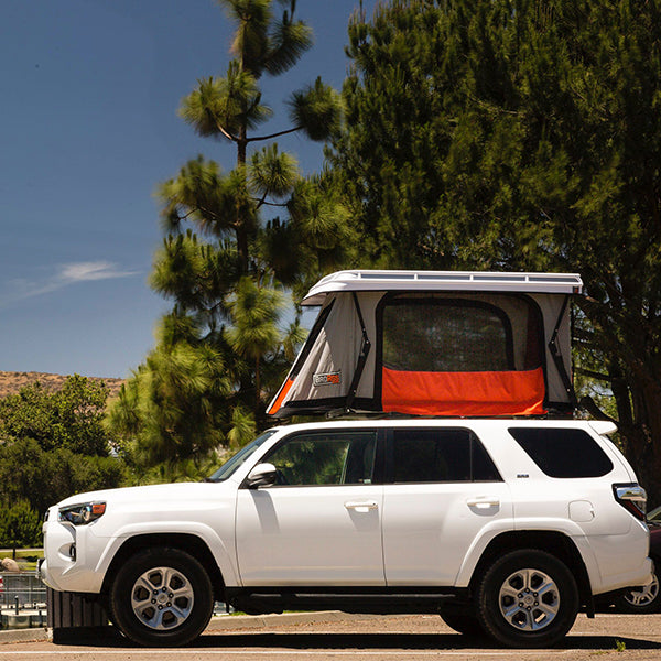 side view of a hard-shell roof top tent toyota 4runner