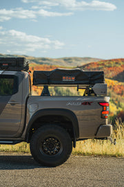 Side view of the 3rd gen nissan frontier with a mounted CBI overland bed rails