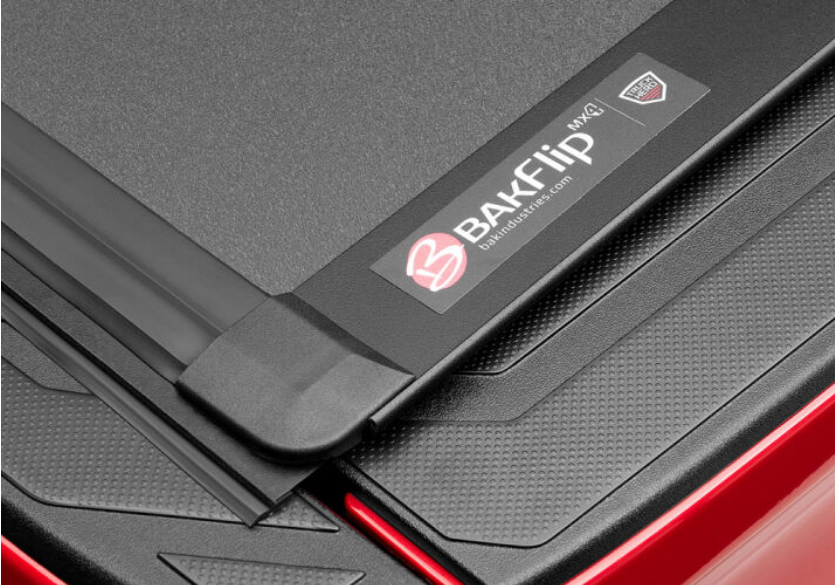 Logo of BAK Industries BAKFlip MX4 Truck Bed Cover W/ Deck Rail System