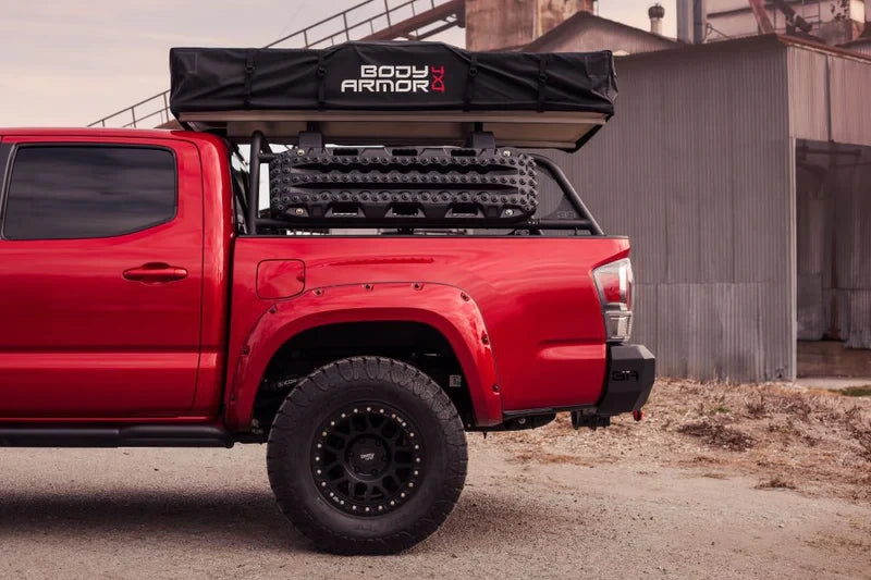 Side view of a truck with the overland rack mounted on it 