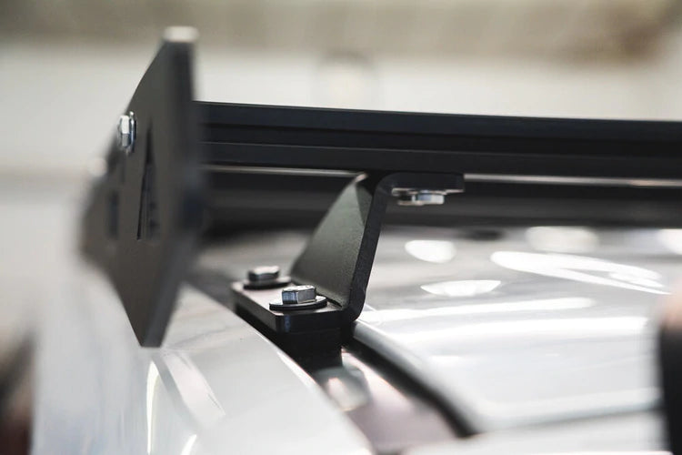 With a  9 extrusion crossbars or by strapping it directly to the side plates.