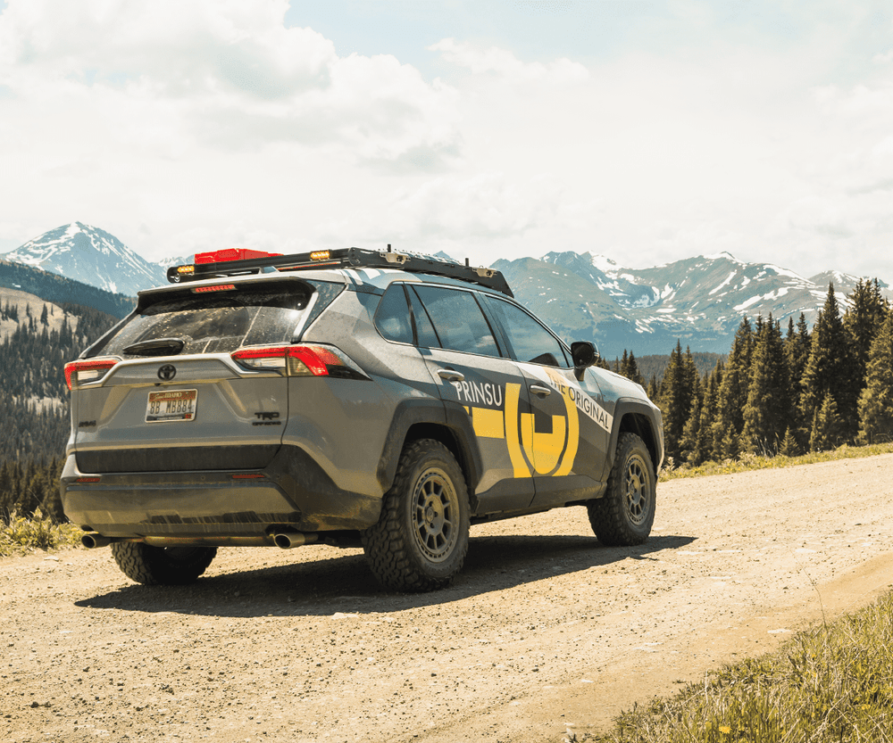 Prinsu Roof Rack on Rav4 parked on the road in front of mountains
