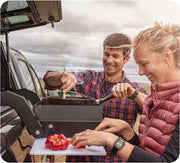 Camp kitchen being used by two people on truck