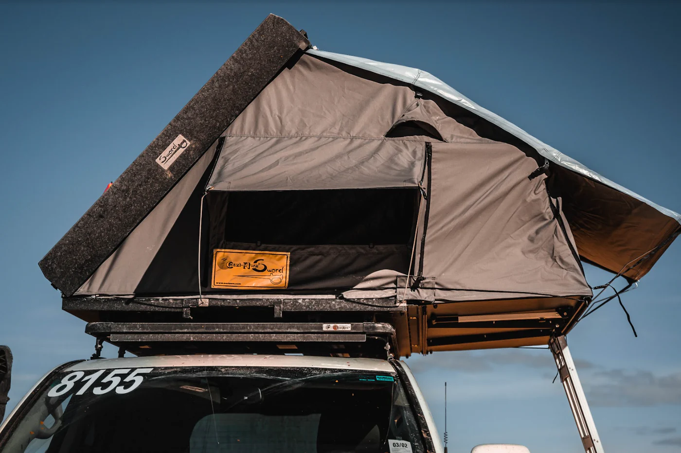Eezi-Awn Sword Hardshell Rooftop Tent Open with Ladder