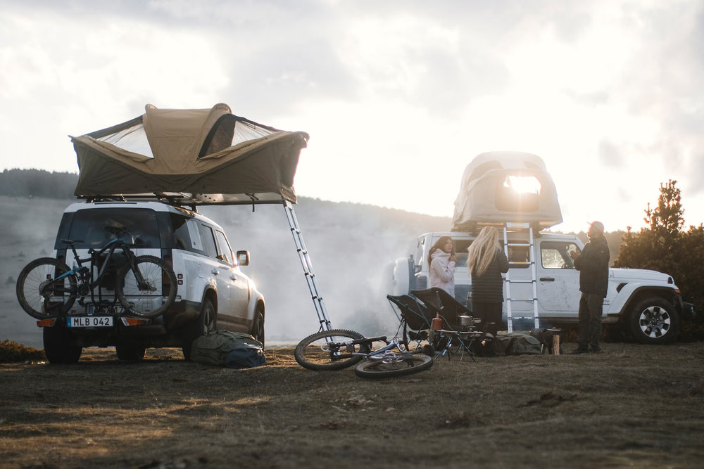 Two Vehicles With Thule Approach M 2-3 Person Roof Top Tent Fennel Tan And Campers Outside