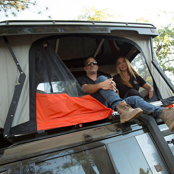 Convoy Land Rover Defender 110 roof top tent with 2 people inside