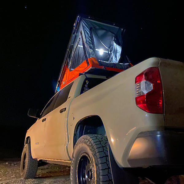 view at night of the BadAss Rugged Rooftop Tent For Toyota Tundra CrewMax 2007-2022