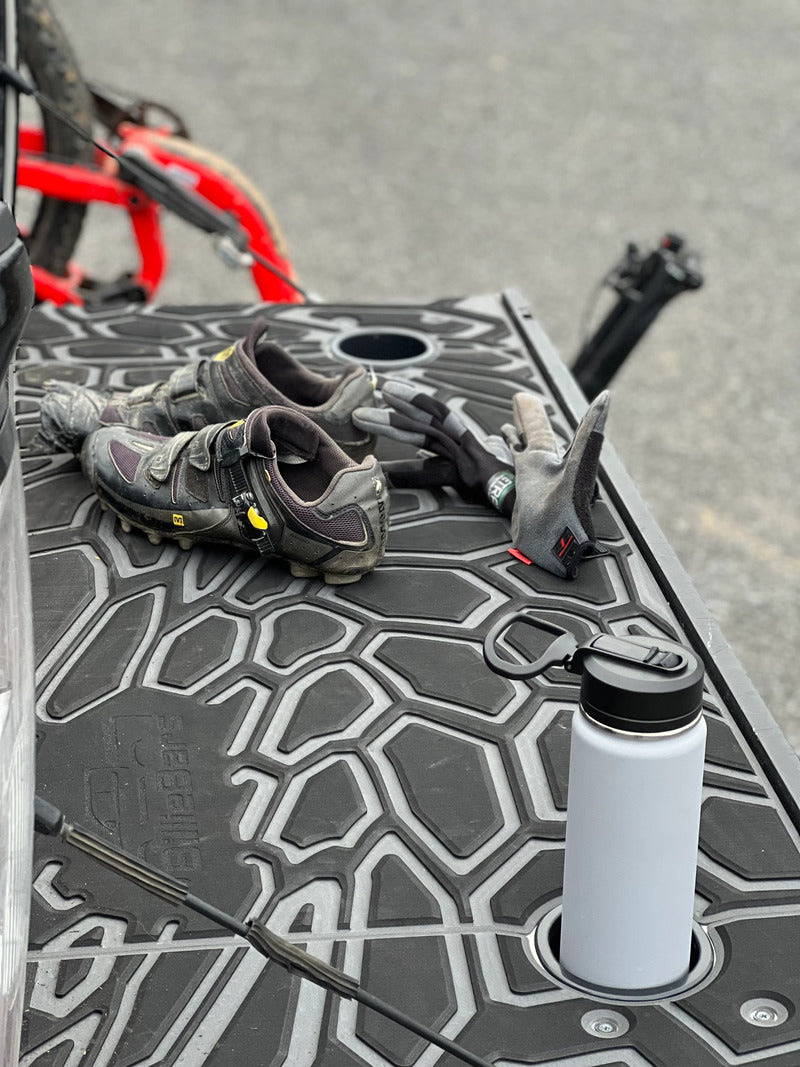 BillieBars Custom Tailgate Cover With A Bottle Inside The Cup Holders And Shoes On The Tailgate Cover
