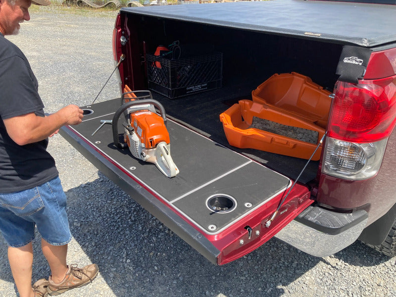 BillieBars Tundra Tailgate Cover With A Chainsaw On Top Of It
