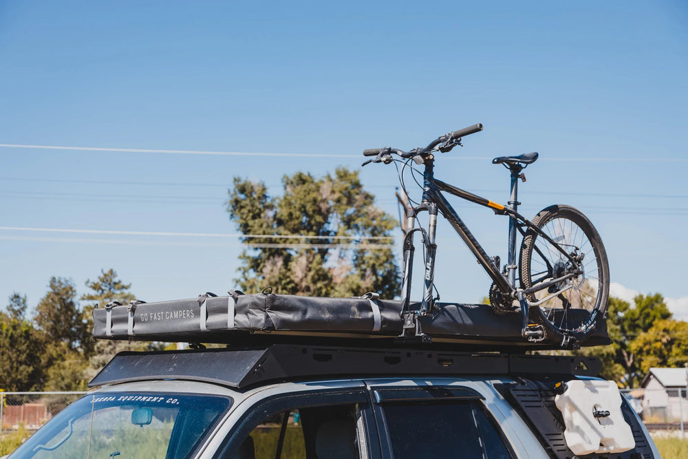 Crossbar Risers Attached to a Vehicle Carrying a Bicycle 