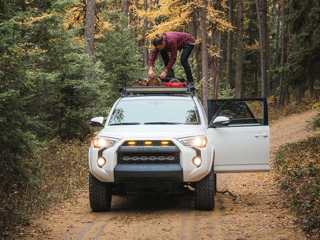 Front Runner 4Runner Rack with a person standing over the roof rack