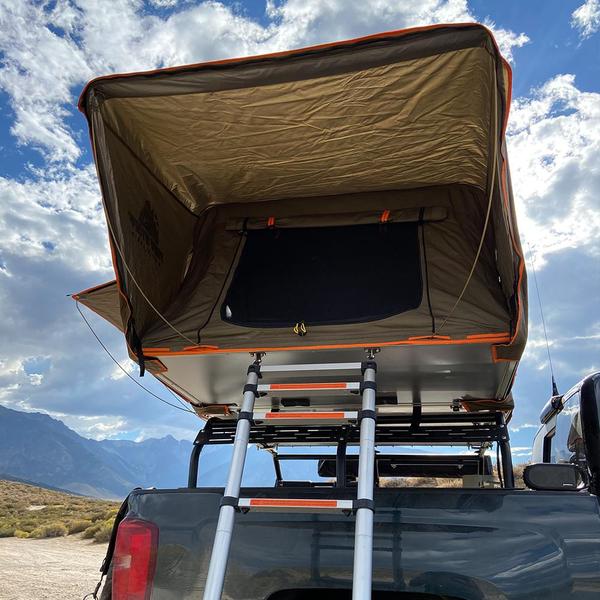 Picture showing the tuff stuff alpha ii roof top tent on top of a bed rack and ladders